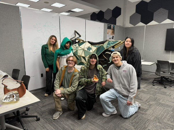 Team posing with the foam core motorcycle prototype